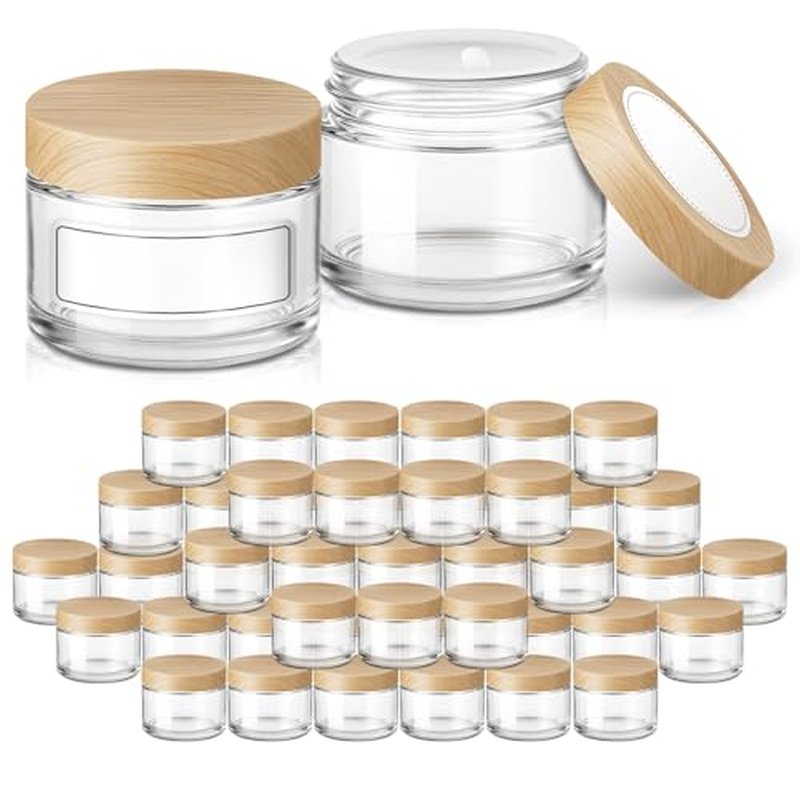 1 oz Glass Jars with Plastic Woodgrain Lids, Bumobum 48 pack Round Clear Cream Jars with Black and White Labels & Inner Liners, Empty Cosmetic Containers for Cream, Lotion, Ointment