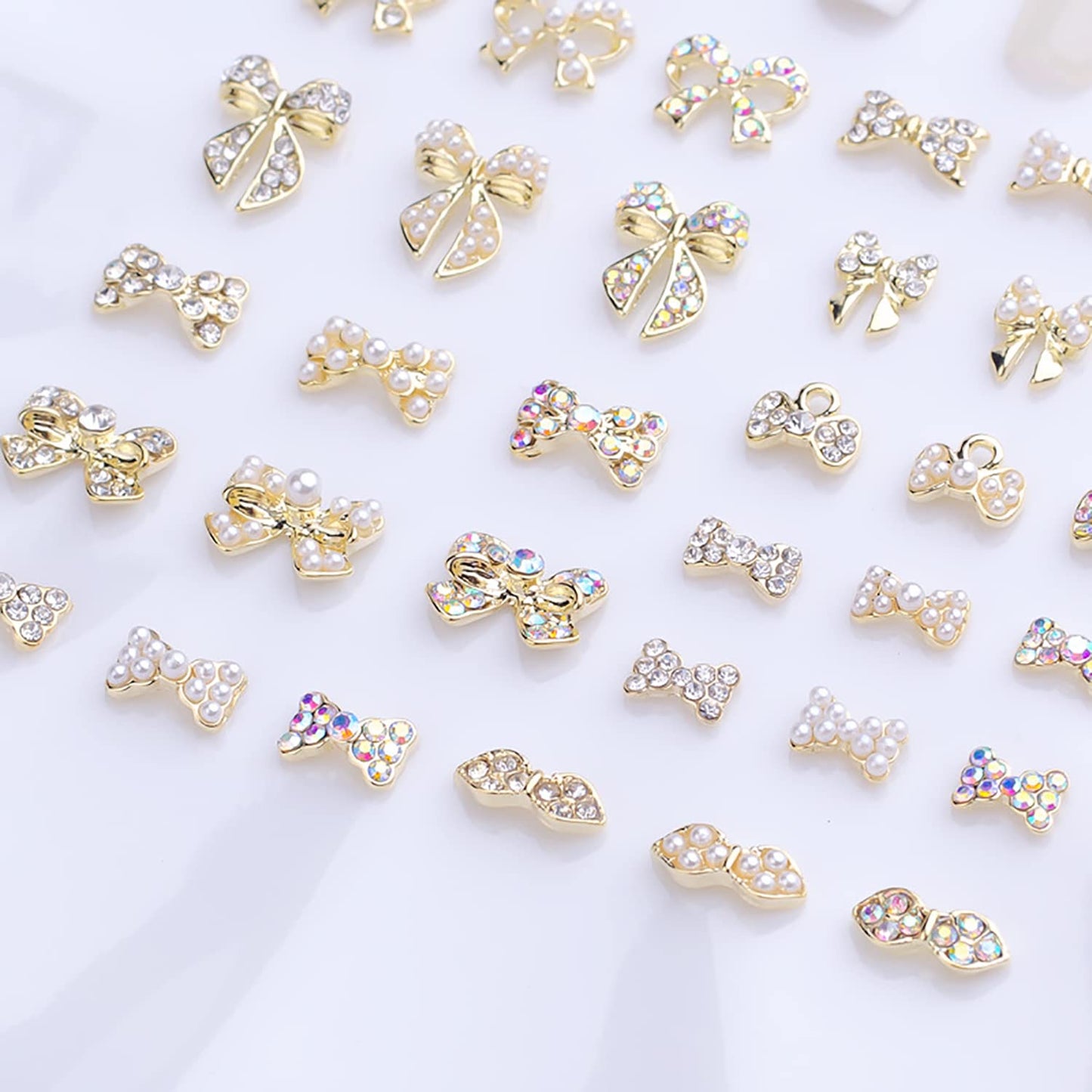 JERCLITY 33 Pieces Gold Alloy Bow Charms for Nails Bow Nail Charms Gems Bowknot Nail Studs Inlaid Pearl Clear Iridescent Rhinestone for Women Nail Art