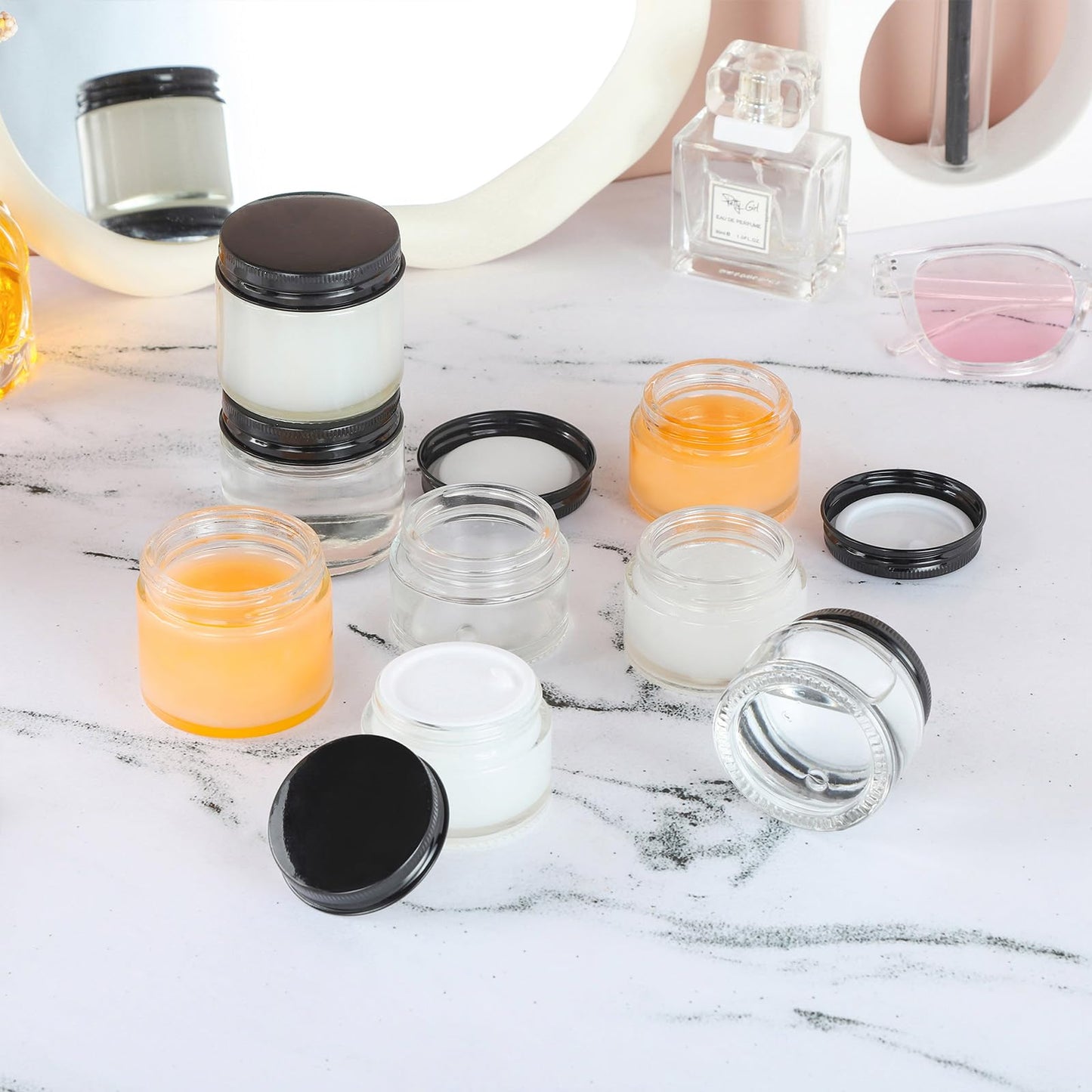 RAMFIYN 24 Pack 2oz Clear Glass Jars Small Glass Containers with Black Metal Lids Empty Cosmetic Jars with Inner Liners and Lids Clear Glass Lotion Jars with Labels for Traveling