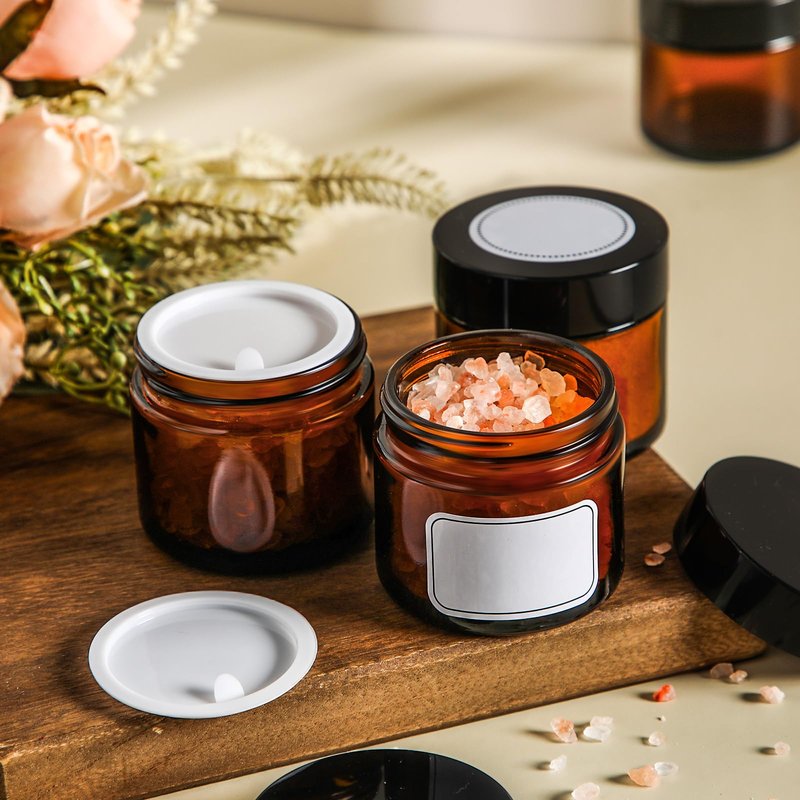 Layhit 24 Pcs 2 oz Glass Jars with Lids Bulk, Small Jars Containers Travel Storage Jar with Inner Liners Labels for Lotions, Cream, Lip Balm (Amber,Black Lid)